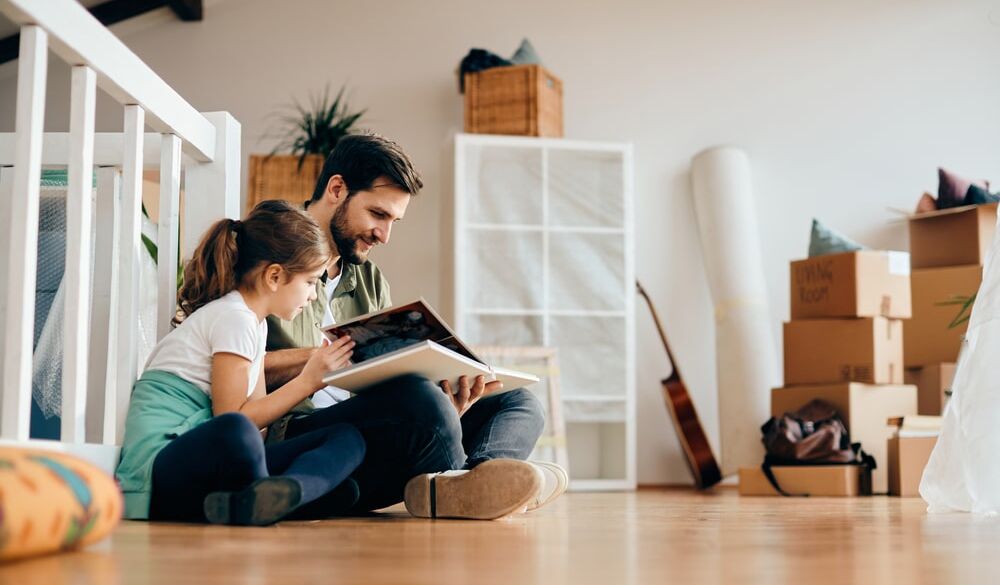 Little girl and her father relaxing on the floor e1694796110608
