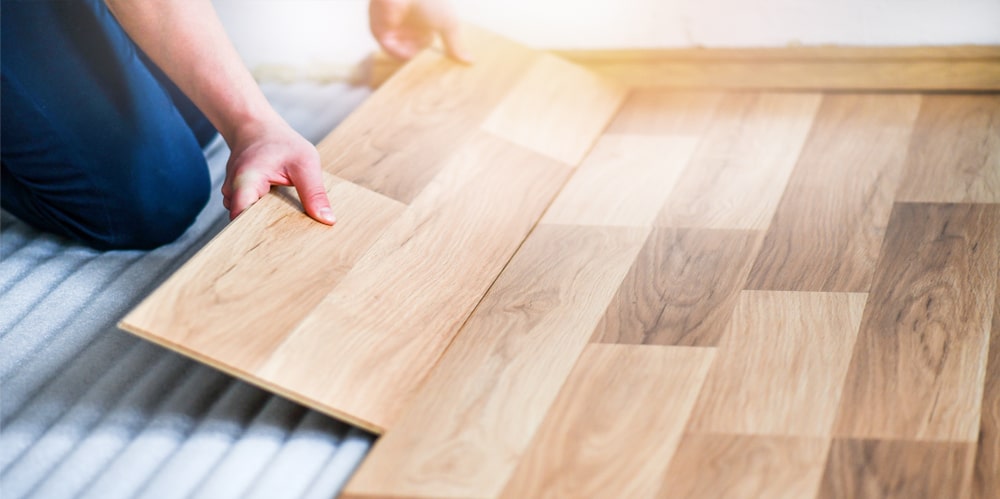 Worker installing laminate flooring deerfoot carpet flooring